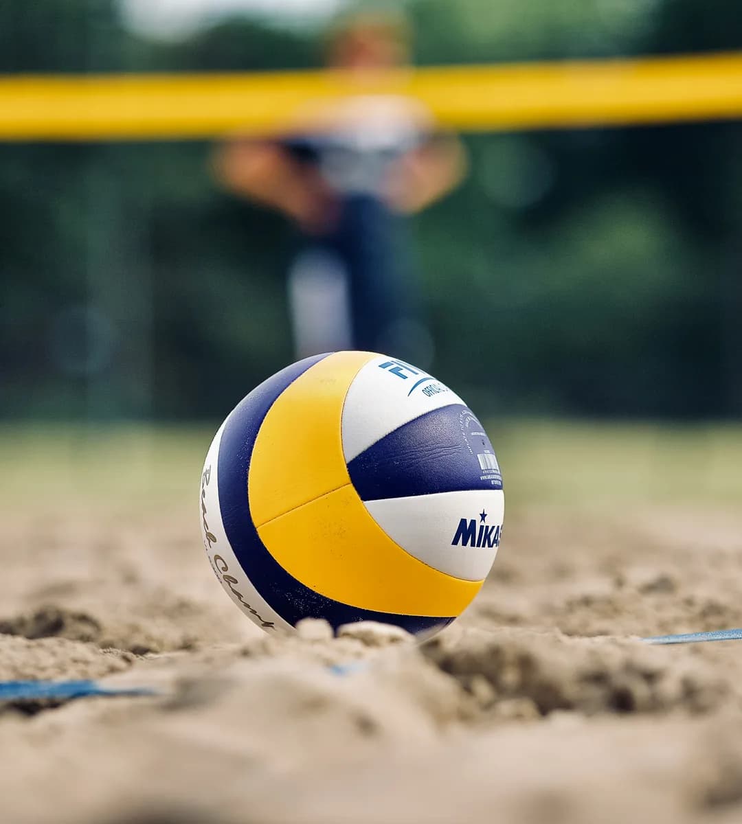 Photo by Miguel Teirlinck on Unsplash Volleyball on the sand at a beach volleyball court
